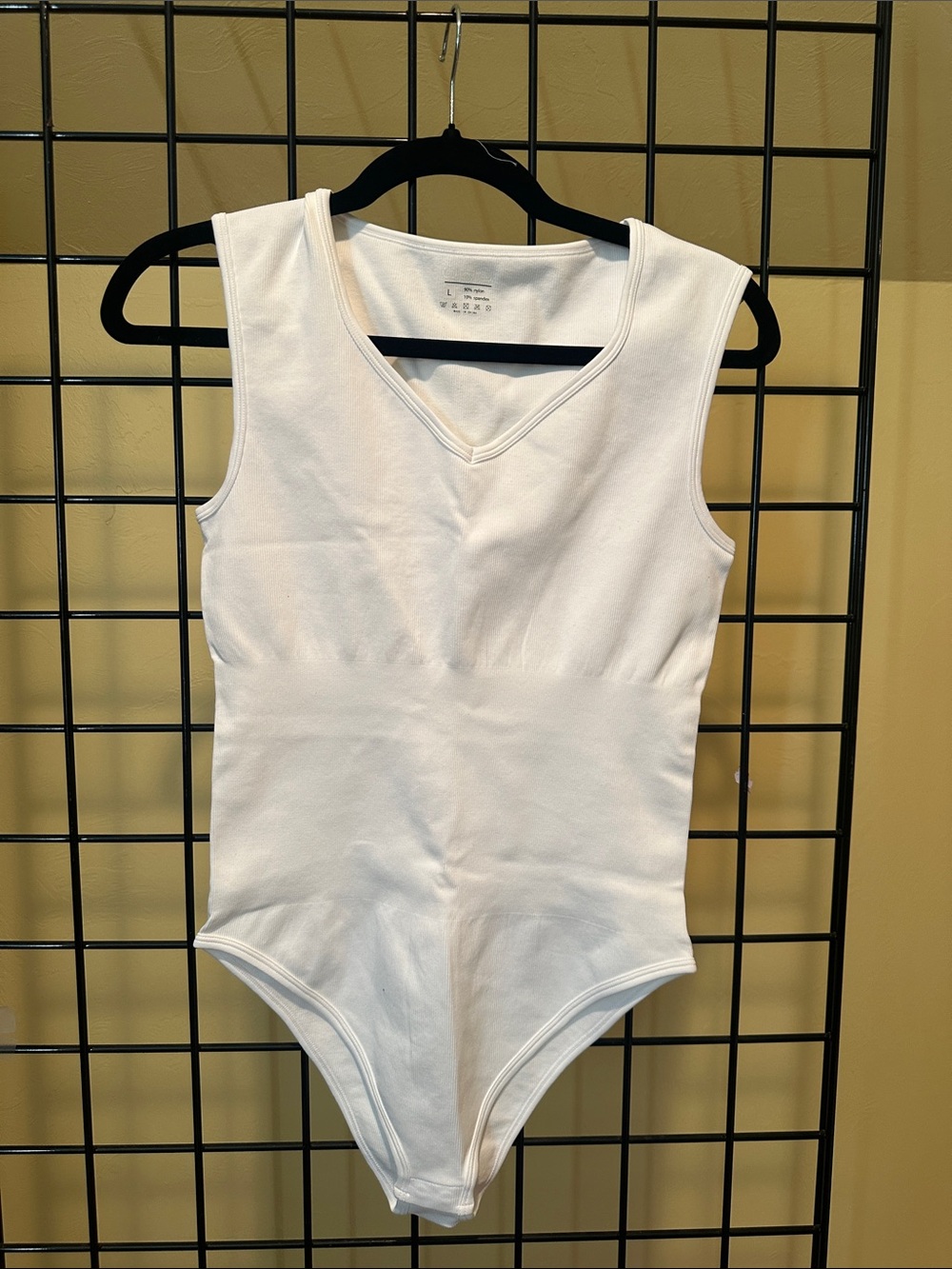 OQQ White Sleeveless One-Piece Bodysuit with Compression